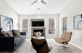 A living room with a fireplace, a chair, and a couch.